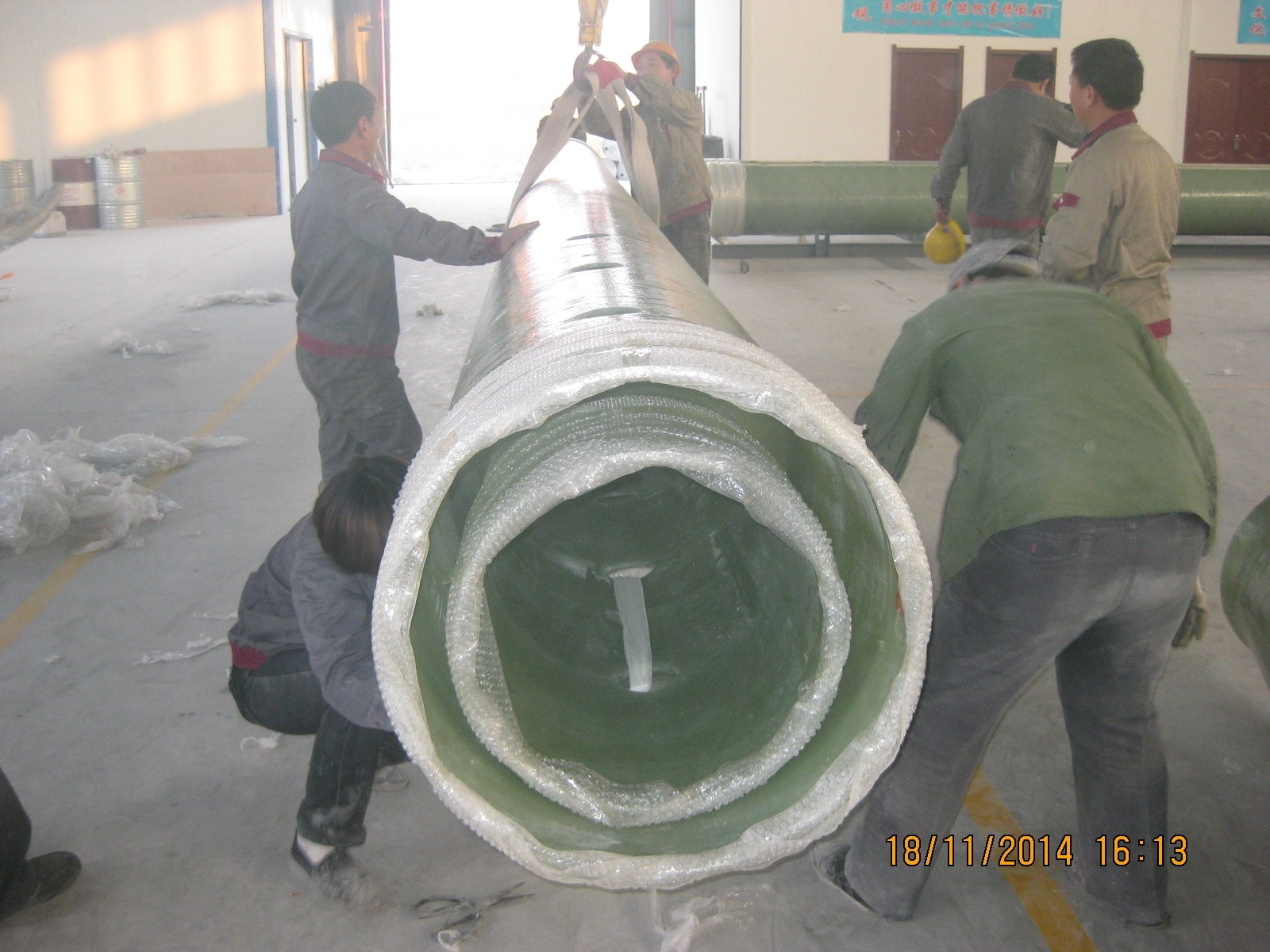 FRP straight pipe loading at factory, fiberglass reinforced plastic pipes prepared for shipment and handling