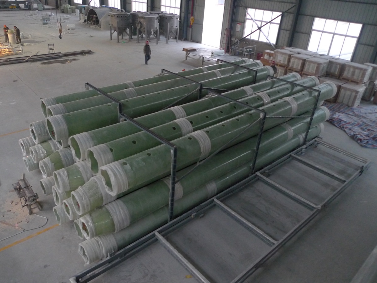 FRP straight pipe export packing for shipment, fiberglass reinforced plastic pipes secured on pallets in factory